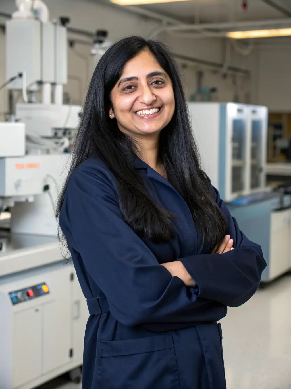 A professional headshot of Dr. Anya Sharma, a leading expert in AI and machine learning for startups, speaking at a conference, with a warm and engaging smile.