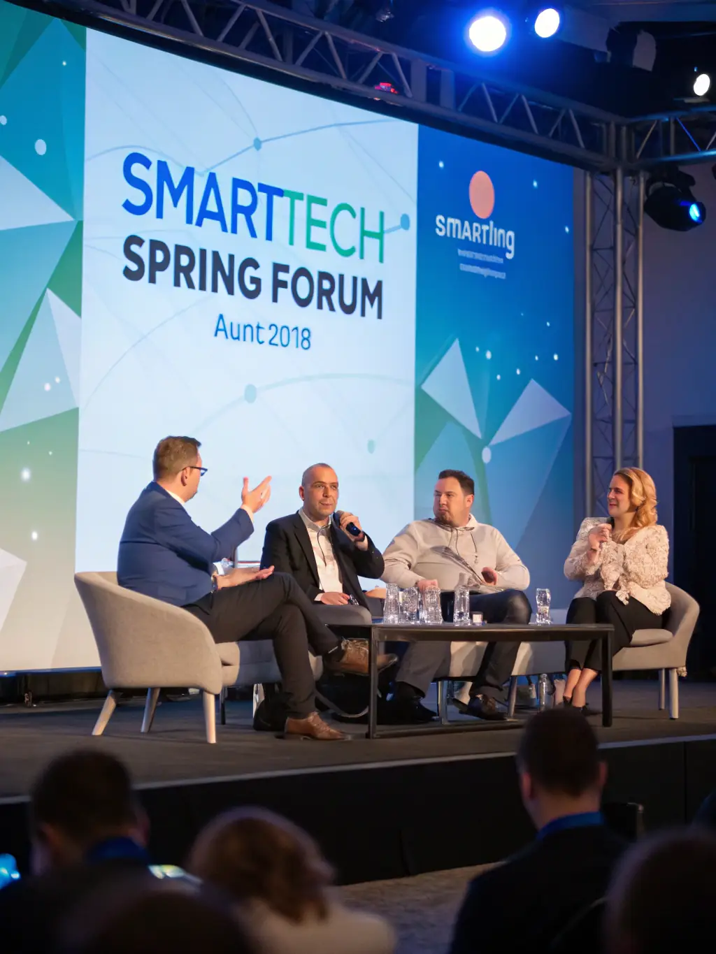 A close-up shot of a panel discussion at a FreshMotion conference, with four panelists engaging in a lively debate on the future of entrepreneurship in India.